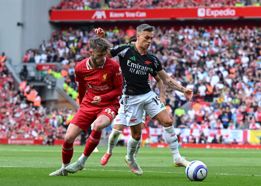 IMAGO Liverpool defender Conor Bradley fights for possession with Arsenal forward Leandro Trossard